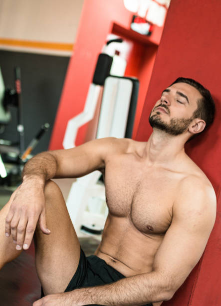 istock tired man resting on the wall at gym 2198652906