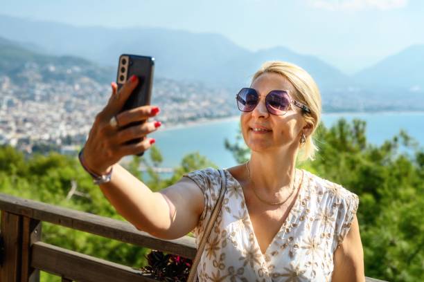 istock Female tourist taking a selfie in old town 2198653216