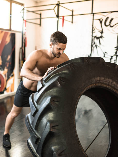 istock man doing a cross training with a truck tire 2198653242