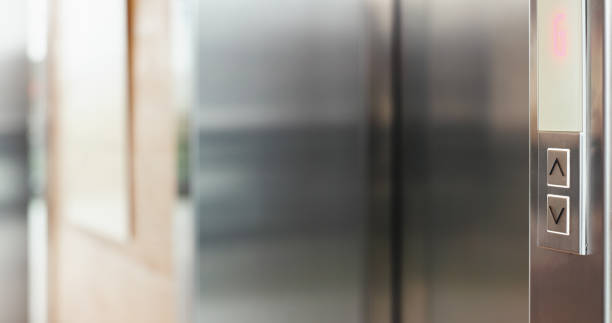 istock Arrow, button and elevator in office building for up or down direction for arrival at floor of choice. Press, push and select with electronic lift service in corporate workplace for convenience 2198654895