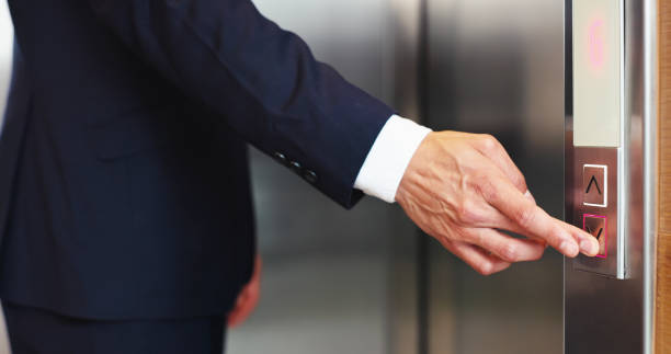 istock Hands, business person and press elevator, transport technology and arrow to request down floor. Office, call lift and push button for travel, work trip and level choice in corporate hotel lobby 2198654907