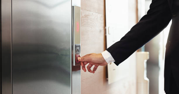 istock Hands, office and person press elevator, transport technology and arrow to request down floor. Business, call lift and push button for travel, work trip and level choice in corporate hotel lobby 2198654913