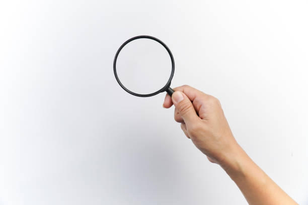 istock Woman Hand Holding a Magnifying Glass on White Background 2198656743