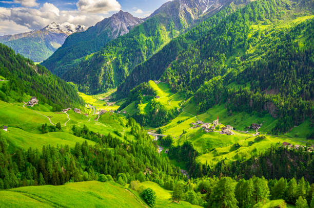 View on Corvara Rabenstein village along the Timmelsjocher Strasse with the Sacred Heart of Jesus Church Kirche und Friedhof Rabenstein in South Tyrol in the Italian Alps during a springtime evening.