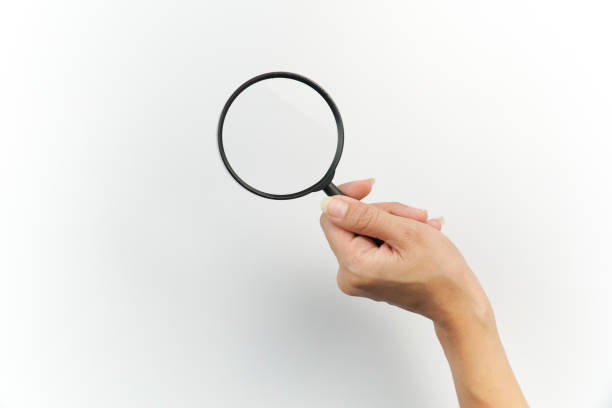 istock Woman Hand Holding a Magnifying Glass on White Background 2198656867