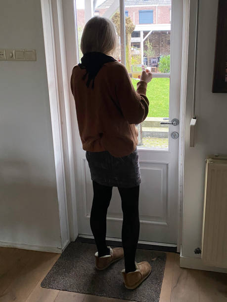 istock Retired Woman staring through the Window. 2198658872