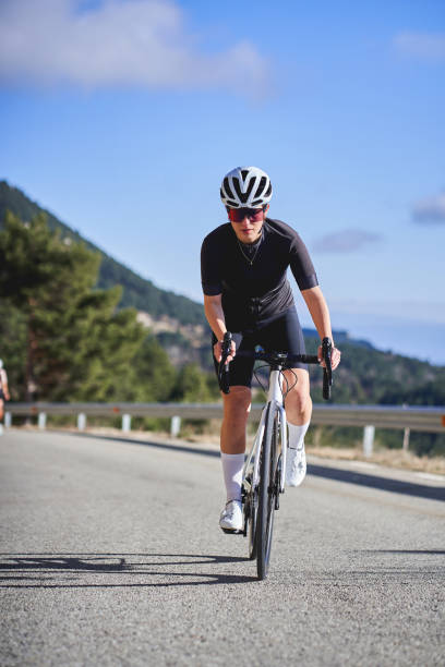 istock Athletic woman pedaling uphill on a scenic route 2198661636