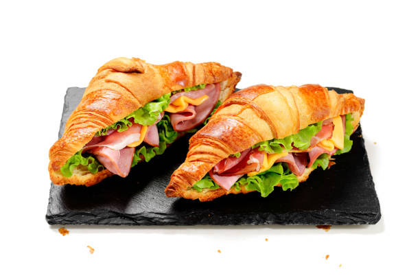 istock Fresh croissant sandwiches with ham, cheese and salad leaf 2198661766