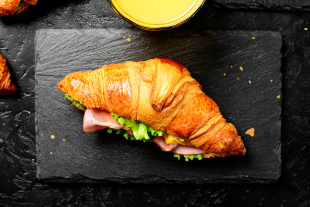 istock Fresh croissant sandwiches with ham, cheese and salad leaf 2198661767