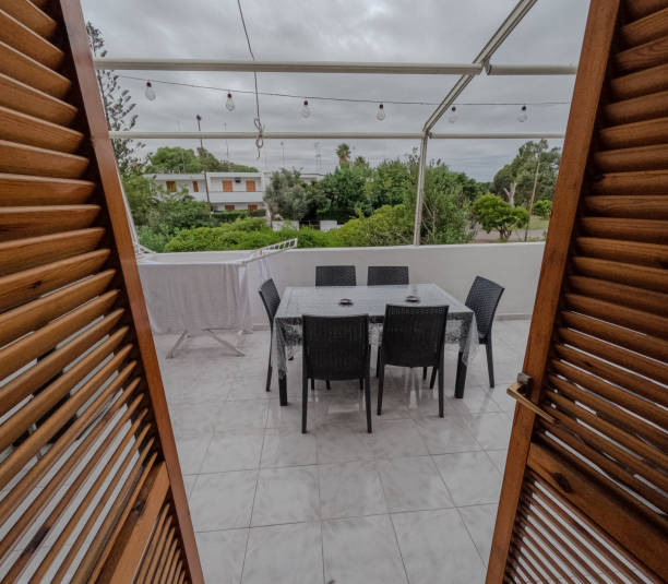 istock Terrace with garden view. Empty plastic table on the terrace. 2198663837