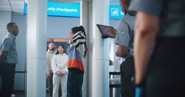 istock Airport Terminal: People with Diverse Ethnicity, Gender Walking Through Metal Detector Scanner 2198667845
