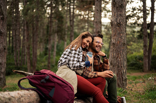 istock Young couple having fun in the forrest while having rest from hiking 2198667979