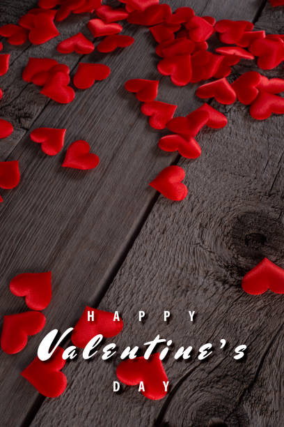 istock Valentine's Day Background with Red Hearts on Rustic Wooden Surface 2198669073