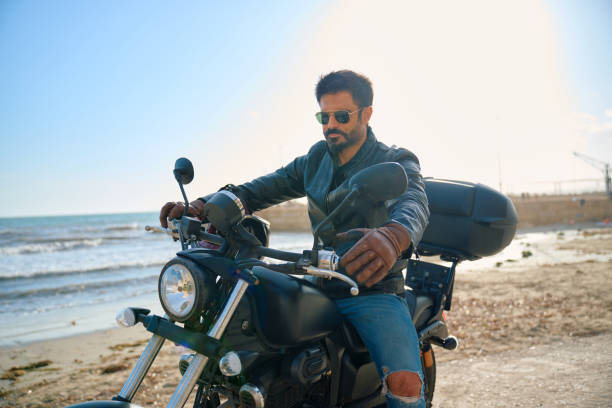 istock Man riding motorcycle near the beach during sunny day 2198670449