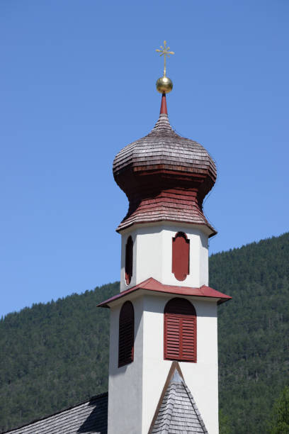 Scenic view of the historic parish church in Ortisei (St. Ulrich), nestled in the picturesque Val Gardena region of South Tyrol, Italy.