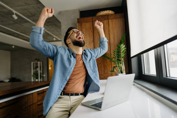 istock Excited freelancer celebrating success while working from home 2198671414