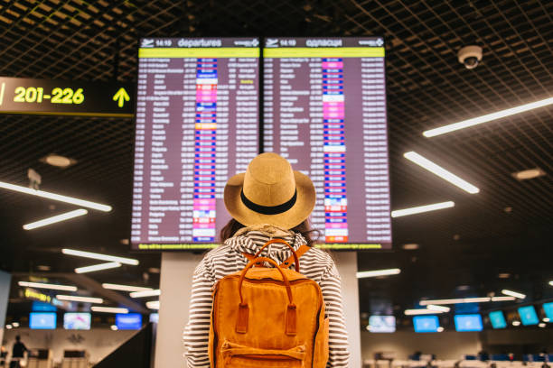 istock Woman looking at arrival departure board 2198671481