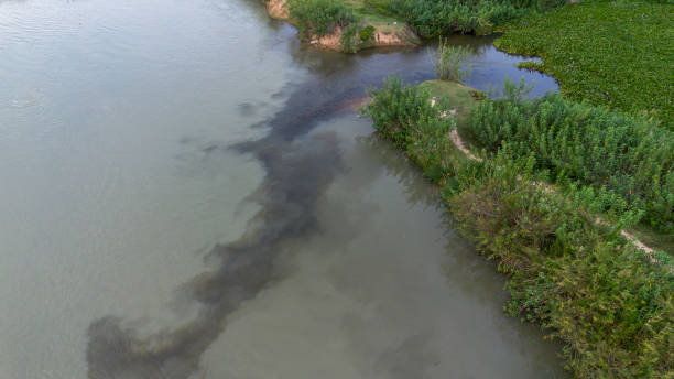 istock Aerial view of river contaminated with black hazardous liquid 2198671718