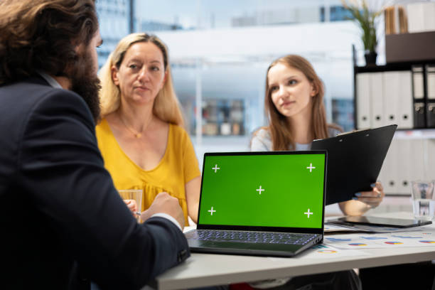 istock Clients checking investment plan on chroma key laptop 2198671770