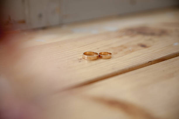 Close up unrecognizable bride putting wedding ring to her groom finger in the wedding ceremony