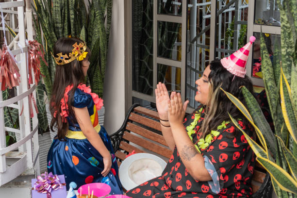 istock Mother clapping hands while celebrating daughter's birthday party 2198673058
