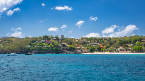 istock Experience a stunning coastal view featuring lush green hills alongside clear blue waters that will mesmerize you 2198676814