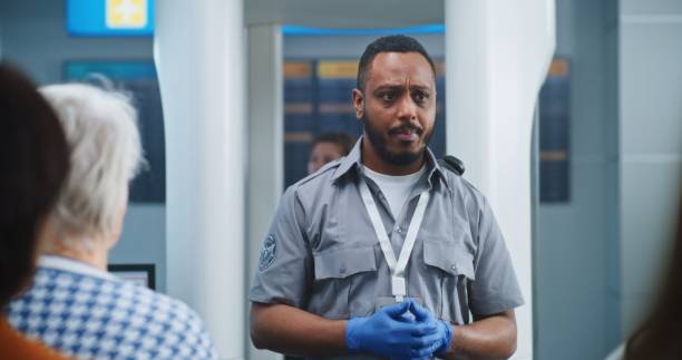 istock Airport Terminal: Security Officer Instructs Diverse People About Metal Detector Scanner Gates 2198677051