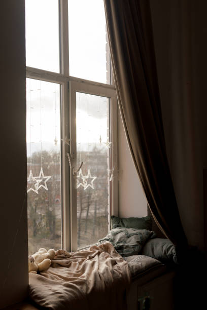 istock A Cozy Window Nook adorned with Beautiful Decorative Pillows and a Soft Throw Blanket 2198677165