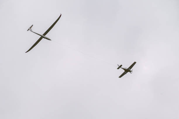 istock Plane towing a glider in gray sky 2198677215