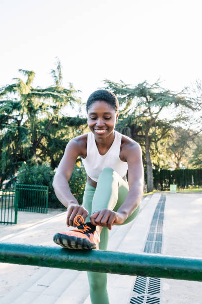 istock Woman tying shoelaces before outdoor exercise 2198680316