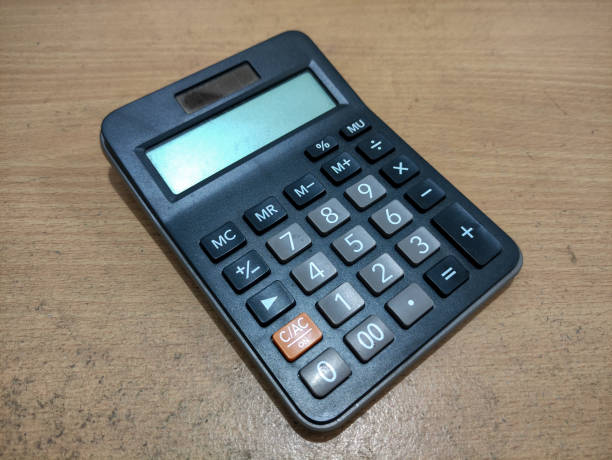 istock Black Solar-Powered Calculator on Wooden Surface in Home Office Setting 2198682976