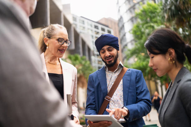 istock A multinational team of business professionals is having an outdoor discussion, using a digital tablet for their work 2198683112