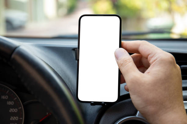 istock male hand holding phone with isolated screen steering wheel car 2198683737
