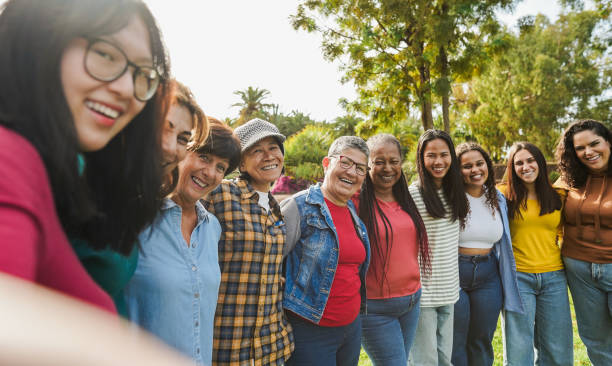 istock Multi generational women smiling in front of camera - Female multiracial group having fun togheter outdoor - Main focus on woman face with glasses 2198684551