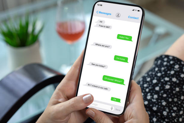 istock woman hands hold phone with app messenger on the screen 2198684599
