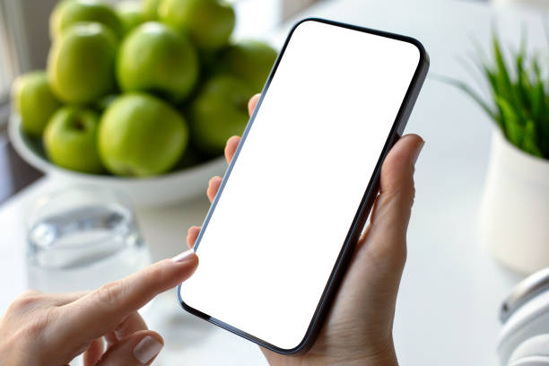 istock female hands hold phone with isolated screen background green apples 2198684879