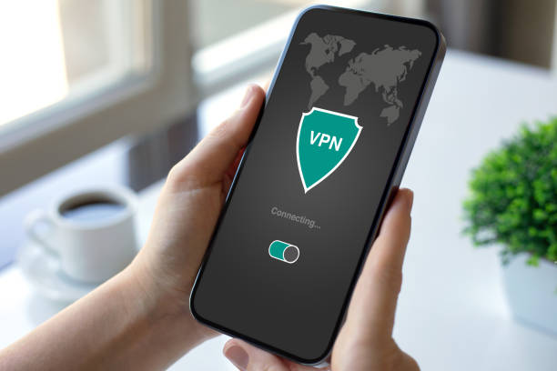 istock female hand holding phone with app vpn on the screen 2198685012