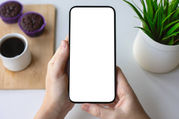istock female hands hold phone isolated screen background table in cafe 2198685093