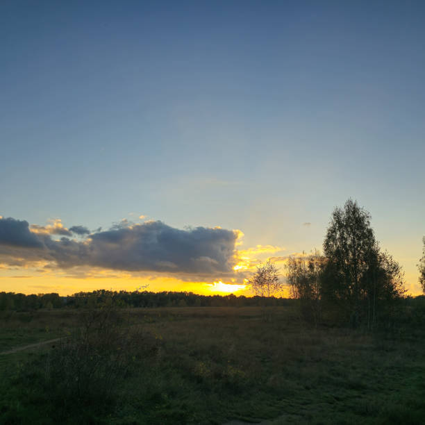 Experience the breathtaking beauty of a sunset casting its warm glow over a tranquil landscape Hannover Langenhagen