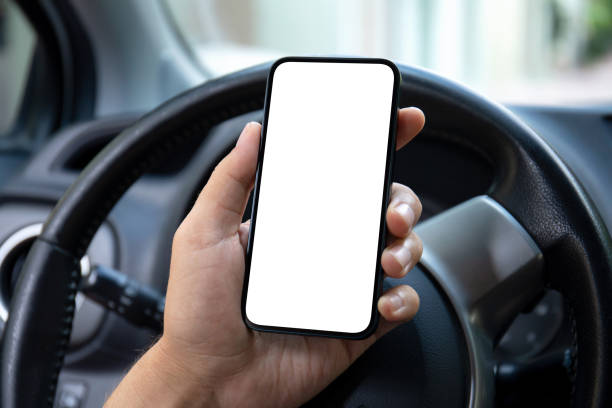 istock male hand hold phone isolated screen background steering wheel car 2198685412
