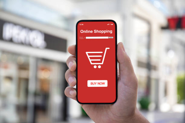 istock Man hand hold phone with online shopping application on screen 2198685414