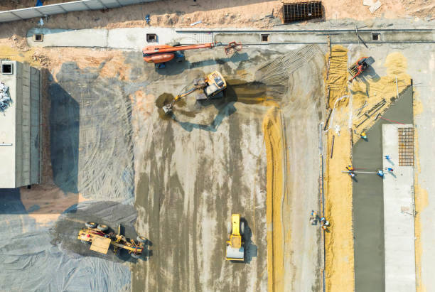 istock Road construction work. A bulldozer on a building site, preparing the soil foundation of a multilane road. High view 2198686044