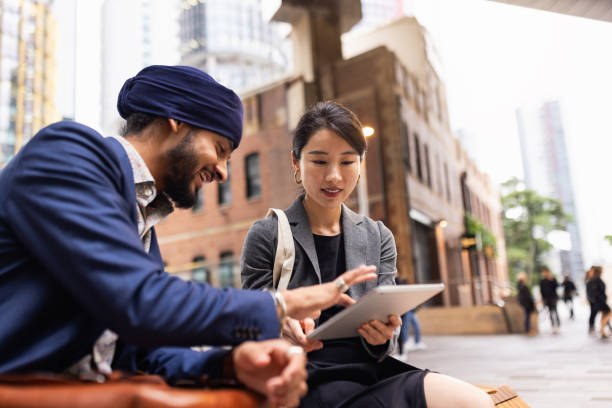 istock Multiracial Business professionals consult using a digital tablet on a bench in Sydney’s downtown district 2198686045