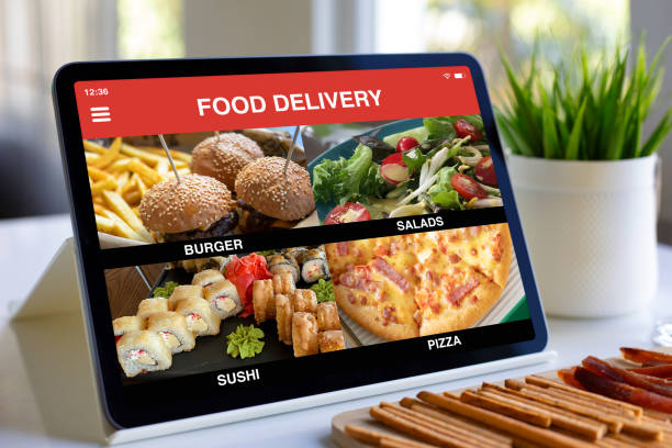 istock computer tablet with food delivery application on screen in cafe 2198686438