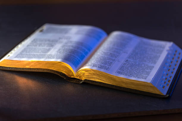 istock Open Holy Bible on the table. Religion concept. Bible on black background. 2198686718