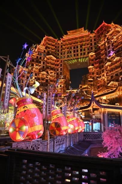 Zhangjiajie, China - December 24, 2024: Night View of The 72 Qi Lou. Colourful buildings on stilts at night with street markets. The strange building of Hunan at night
