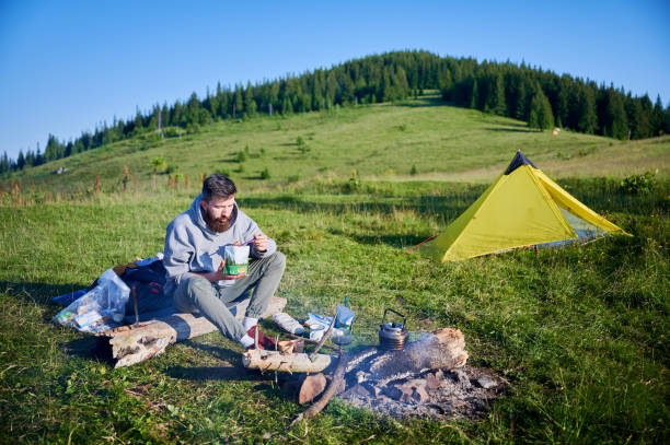 istock Bearded man eating from food pouch 2198688279