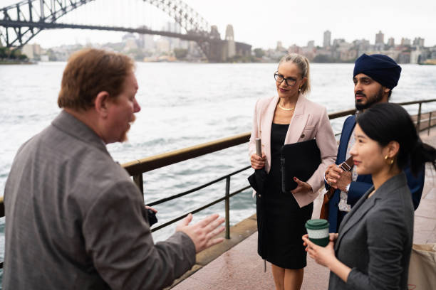 istock Multiracial Business Professionals Networking by Sydney Waterfront with Iconic Bridge Backdrop 2198689191