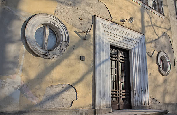 istock Old ruined building with a door and two round shape windows 2198689616