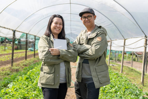 istock Two Asian Researcher Discussion & Examining Plant Seedling 2198689675